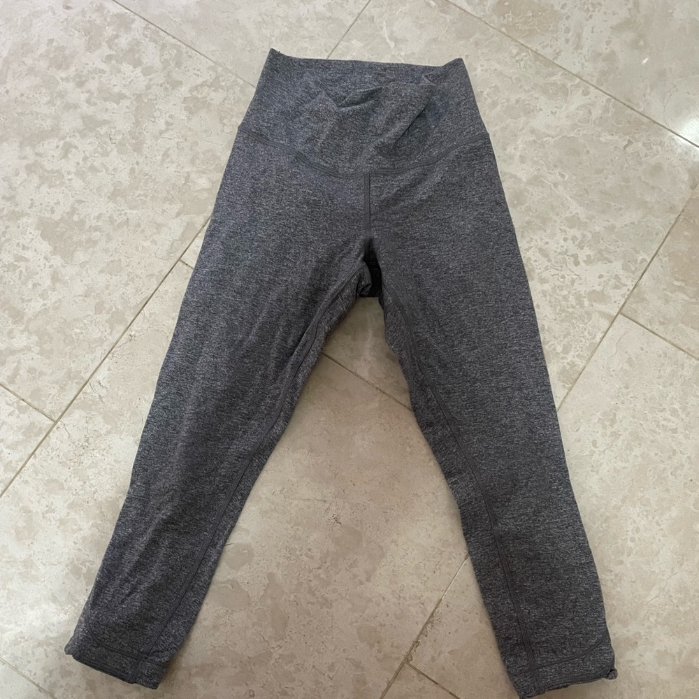 Grey lululemon 3/4 length leggings with cut out details on legs, size four